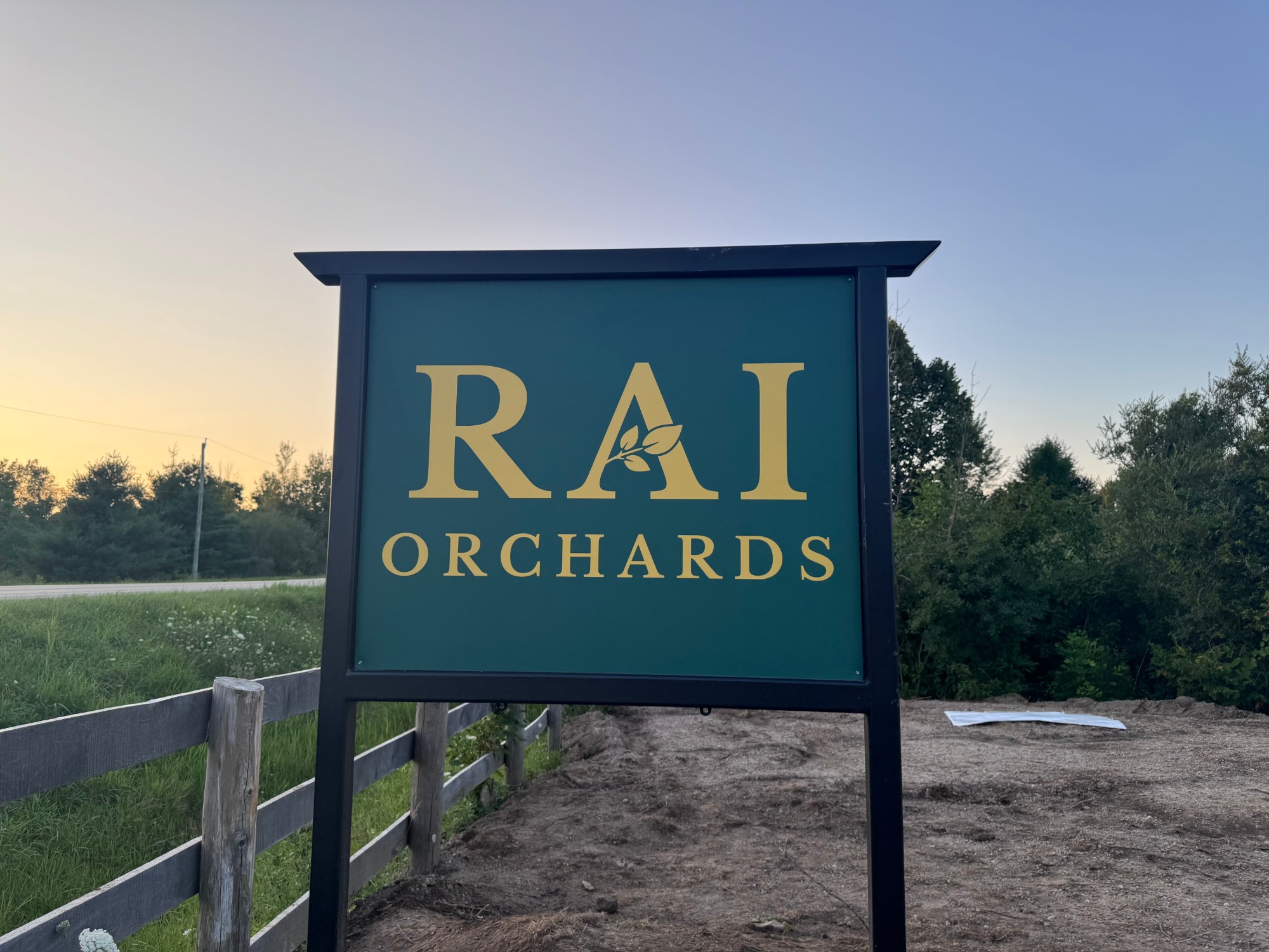 The Rai Orchards sign at sunset